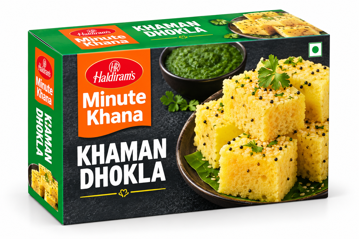 Haldiram’s Minute Khana Khaman Dhokla 256g box featuring green, orange and black packaging, soft yellow dhokla cubes garnished with mustard seeds and coriander, served with green chutney.