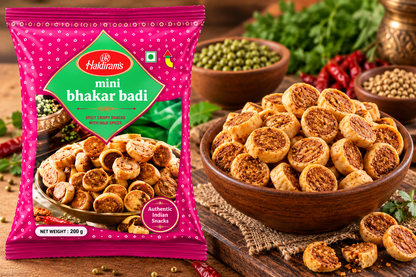 Haldiram Mini Bhakar Badi 200g packet displayed beside a bowl of crispy mini bhakar badi snacks in a traditional food setting.