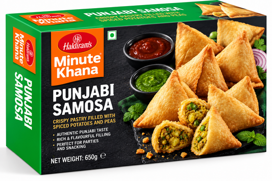 Haldiram’s Minute Khana Punjabi Samosa 650g box featuring green, orange and black packaging, golden crispy samosas filled with spiced potatoes and peas, red and green chutneys, fresh coriander, and Haldiram’s branding.