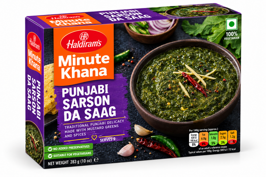 Haldiram’s Minute Khana Punjabi Sarson Da Saag 283g box featuring purple, orange and black packaging, traditional mustard greens curry garnished with ginger and red chilli, alongside fresh green leaves.
