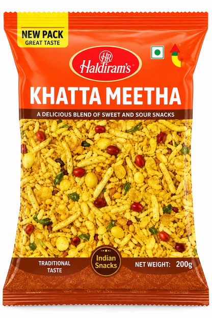 Haldiram’s Khatta Meetha savoury snack mix in an orange packet, featuring a crunchy blend of yellow snack pieces, peanuts and spices.