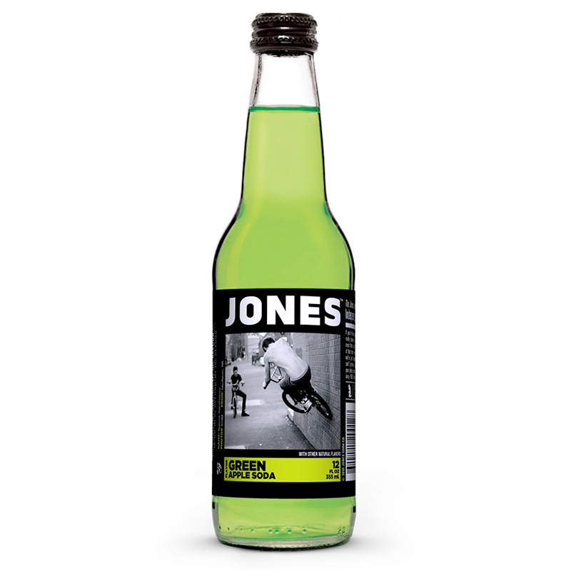 A 355ml glass bottle of Jones Soda Green Apple craft soda featuring a bright green apple label and clear glass bottle.