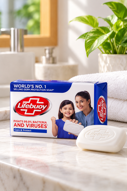 Lifebuoy Care & Protect Soap 123g pack displayed on a bright bathroom countertop beside a white Lifebuoy soap bar, a folded white towel, and a green potted plant.