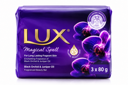 Lux Purple Magical Spell Soap 3 Pack x 80g featuring glossy deep purple packaging with metallic gold Lux branding, elegant purple orchid flower illustrations, a floral beauty oil emblem, and Black Orchid and Juniper Oil fragrance details. The multipack highlights long-lasting fragrance and a luxurious floral beauty bar, displayed upright against a clean white background with the rich violet packaging clearly visible.