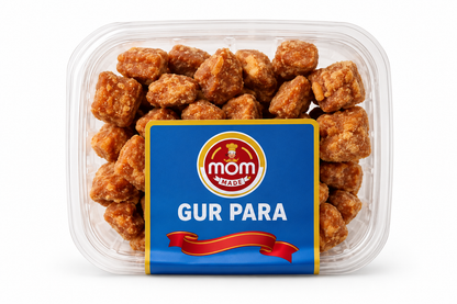 Mom Made Gur Para 300g transparent container with a blue and gold label, filled with crunchy golden-brown jaggery-coated snack pieces.