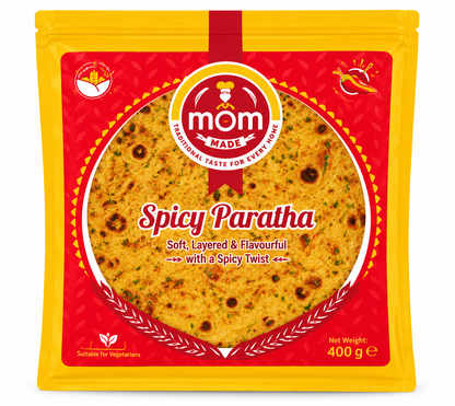 Mom Made Spicy Paratha 400g pack featuring bright yellow and red packaging, the Mom Made logo, and an image of a golden, herb-speckled spicy paratha with browned spots and chilli graphics against a clean white background.
