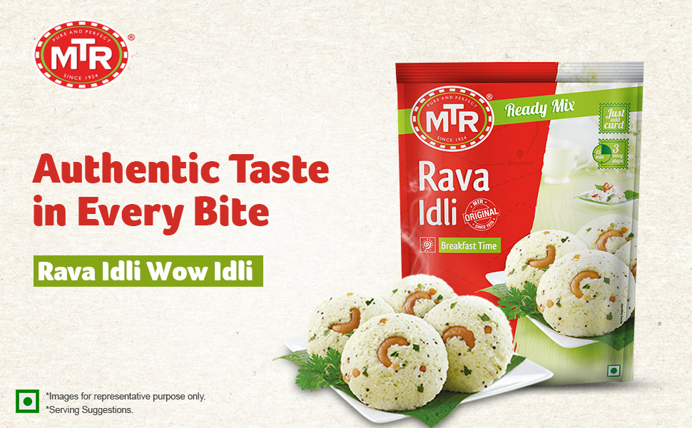 Promotional banner for MTR Rava Idli Ready Mix showing the red and green 500g pack on the right and a plate of fluffy rava idlis garnished with cashews and coriander on the left, with text reading “Authentic Taste in Every Bite” and “Rava Idli Wow Idli.