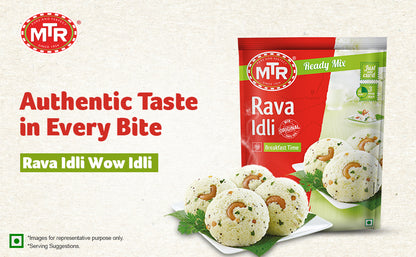 Promotional banner for MTR Rava Idli Ready Mix showing the red and green 500g pack on the right and a plate of fluffy rava idlis garnished with cashews and coriander on the left, with text reading “Authentic Taste in Every Bite” and “Rava Idli Wow Idli.
