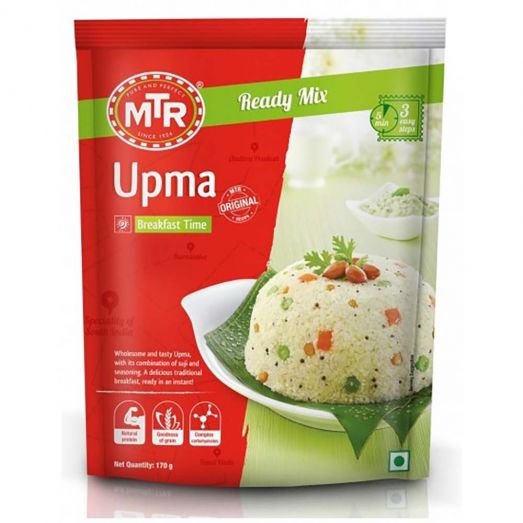 Front view of MTR Upma Ready Mix packet with red and green packaging, showing a bowl-shaped serving of vegetable upma garnished with peanuts and herbs on a white plate, labeled “Ready Mix” and “Breakfast Time.