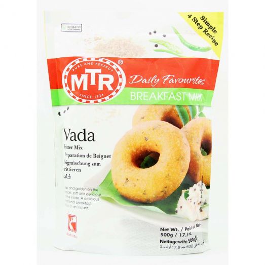 Front view of MTR Vada Breakfast Mix 500g packet with white and red packaging, featuring golden doughnut-shaped medu vadas on a green leaf with coconut chutney, labeled “Daily Favourites” and “Breakfast Mix