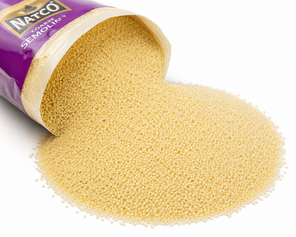 Natco Coarse Semolina spilling from an opened 500g pack onto a white background, showing premium durum wheat semolina granules.