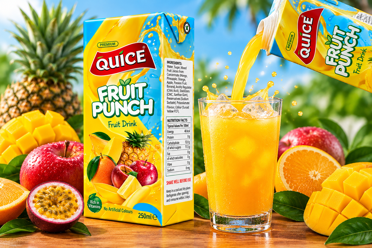 Quice Fruit Punch beverage being poured from a carton into a glass filled with ice, surrounded by fresh tropical fruits and green leaves.