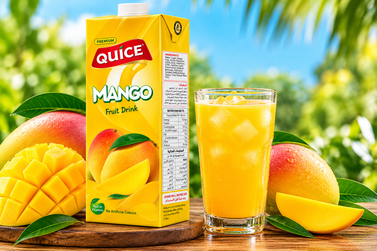 Quice Mango Fruit Drink multipack of six 250ml cartons beside a glass of chilled mango drink and fresh mango slices.