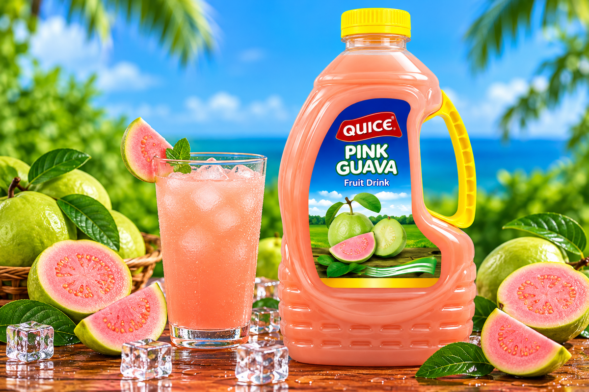Quice Pink Guava Fruit Drink 2L bottle beside a glass of chilled pink guava beverage with ice cubes, fresh guava slices and green leaves.
