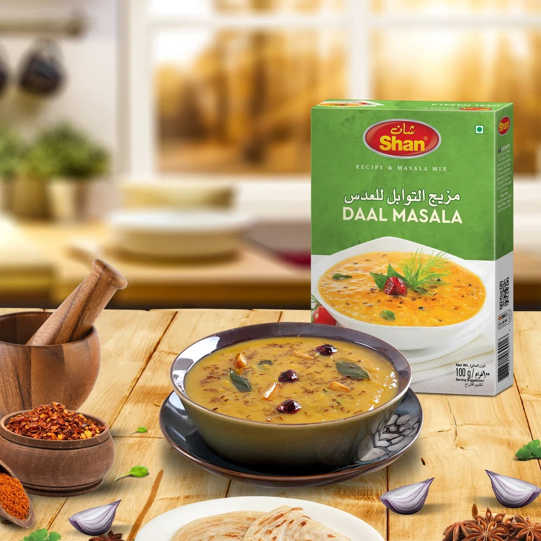 Shan Daal Masala box with a bowl of daal on a wooden table
